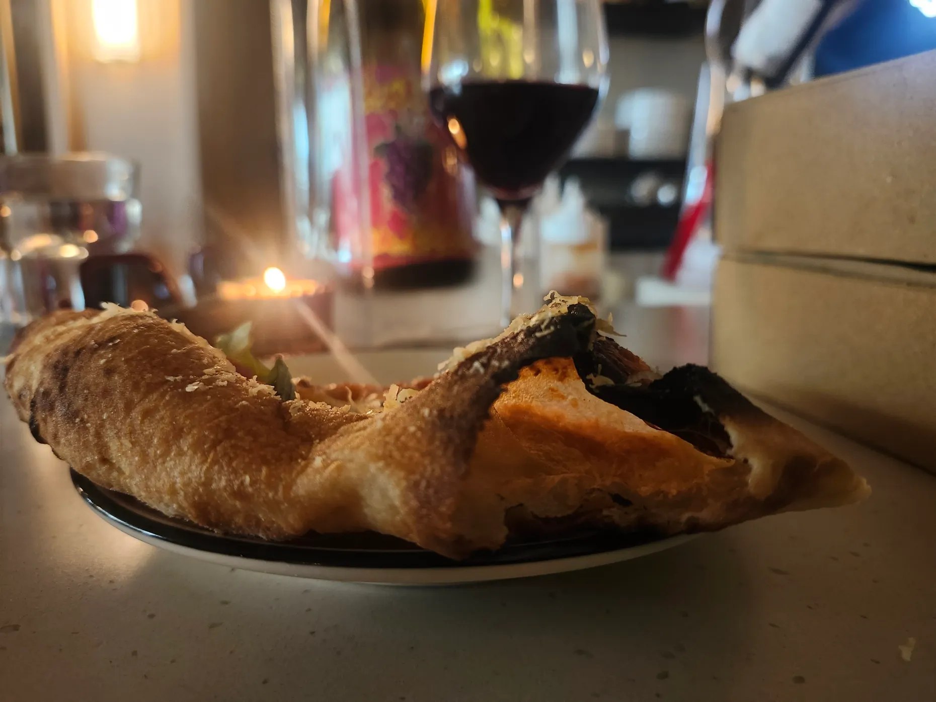 A slice of Burnt Mouth Pizza by candlelight at Quicksand Wine in Orlando